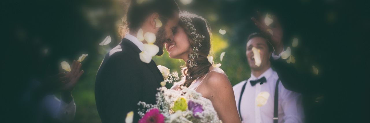 Struggling With Uncertainty as a Person With Autism Bride and groom kissing on their wedding day.