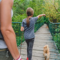 A mother and daughter walking in a forest.