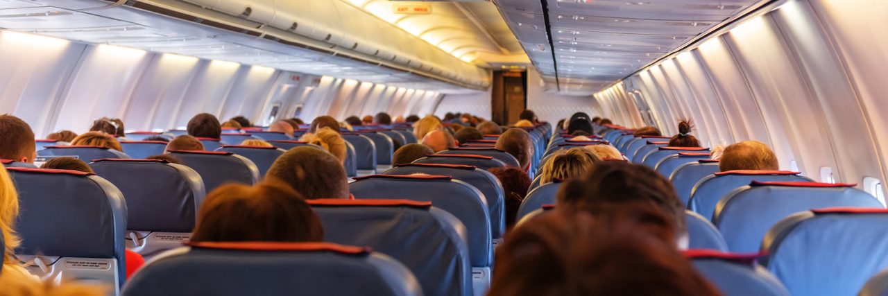 Interior of airplane with passengers.