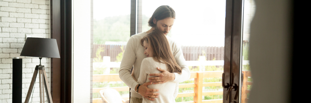 What My Boyfriend Told Me When Illness Made Me Question My Identity A picture of a man and woman hugging, while the woman looks to be upset.