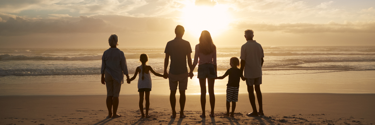 Lessons Learned After My Son's Traumatic Brain Injury silhouette of a family on a beach