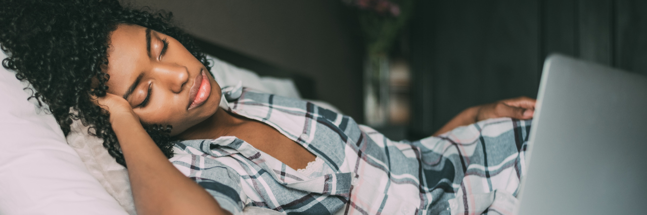 Why a Gas Tank Is a Better Metaphor for Chronic Pain Than Spoon Theory woman on bed with laptop sleeping