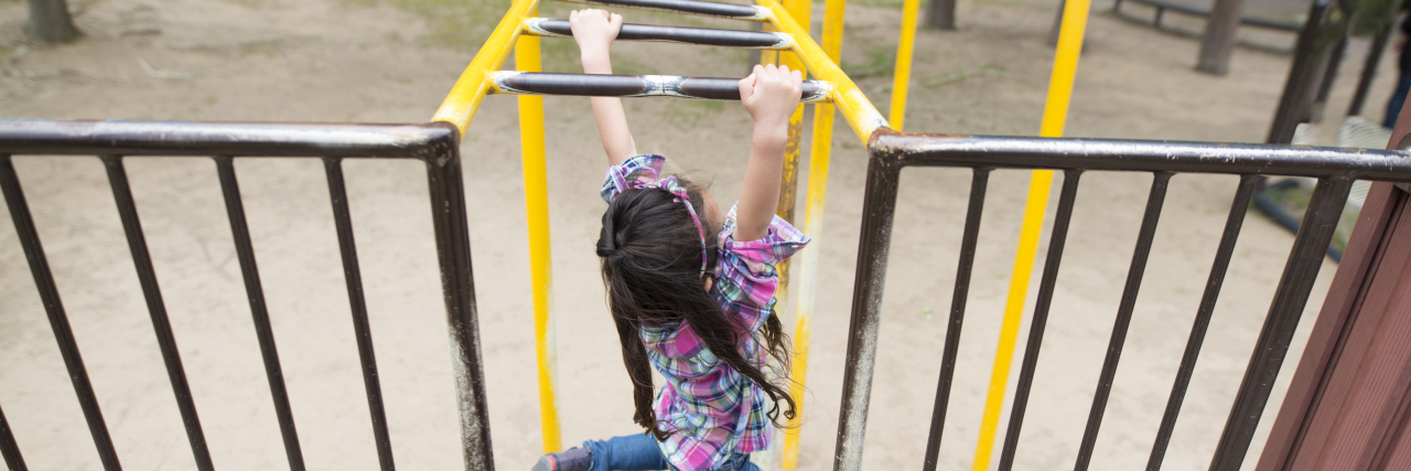 Autism and Lessons From the Edge of the Playground Little girl playing in the park.