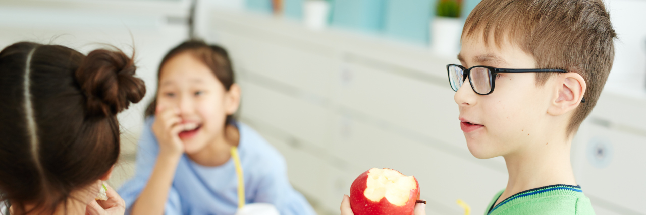 What It's Like to Be a Parent of a Child With Food Allergies Three children eating snacks sitting on a school table