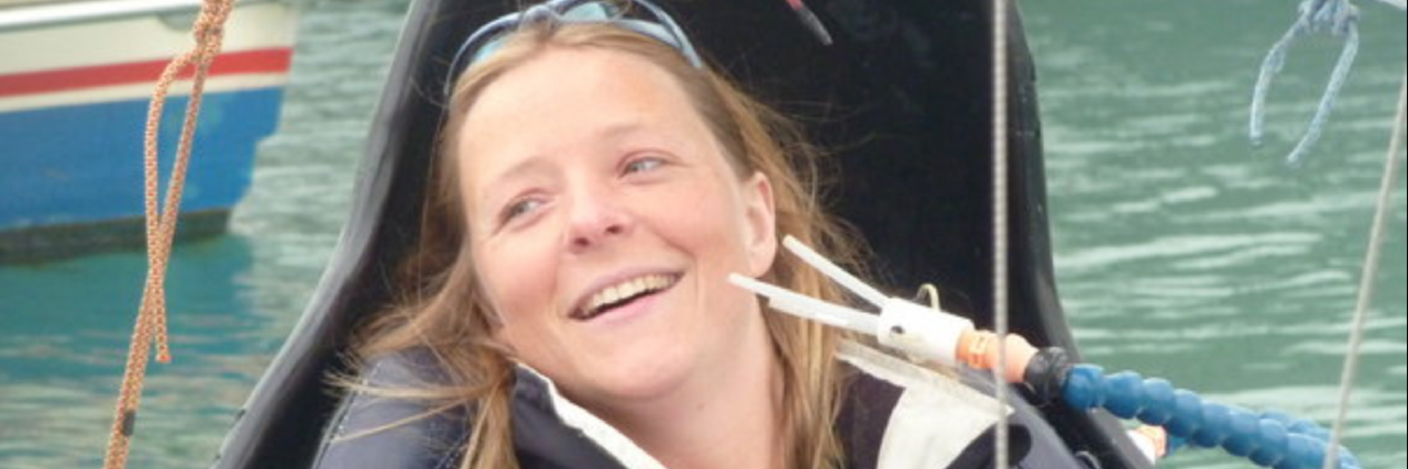Disabled Sailor Hilary Lister Dies at 46 Hilary Lister sitting on a boat with her sip and puff tubes near her face.