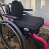 A pink and black wheelchair