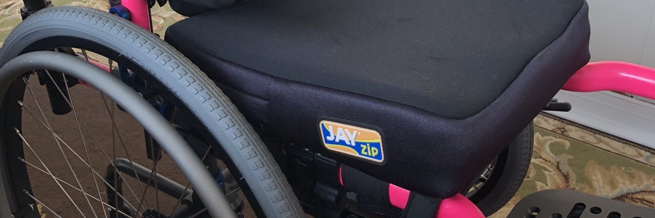 A pink and black wheelchair