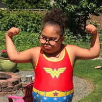 Two images: one of Megan Sherrill and Laylah, second of Laylah wearing Wonderwoman swimming suit and arms up showing she is powerful