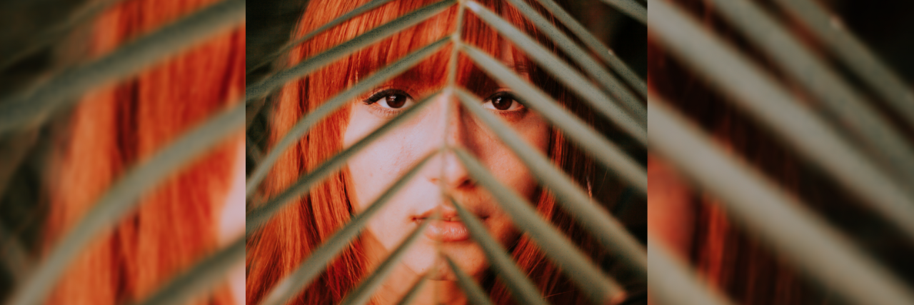 woman face behind leaf