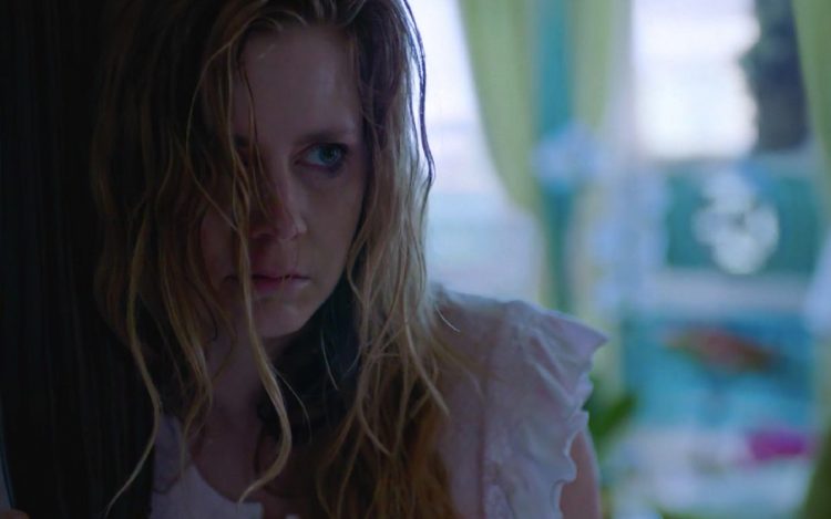 Amy Adams in Sharp Objects. Her character, Camille, is wearing a white night gown and looks sweaty and sick