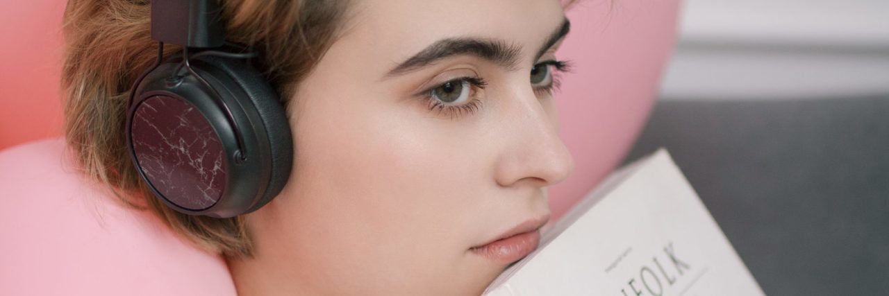 What Logic’s '1-800-273-8255' Means to Me Now That I’m Not Suicidal young woman with short hair listening to music and feeling contemplative