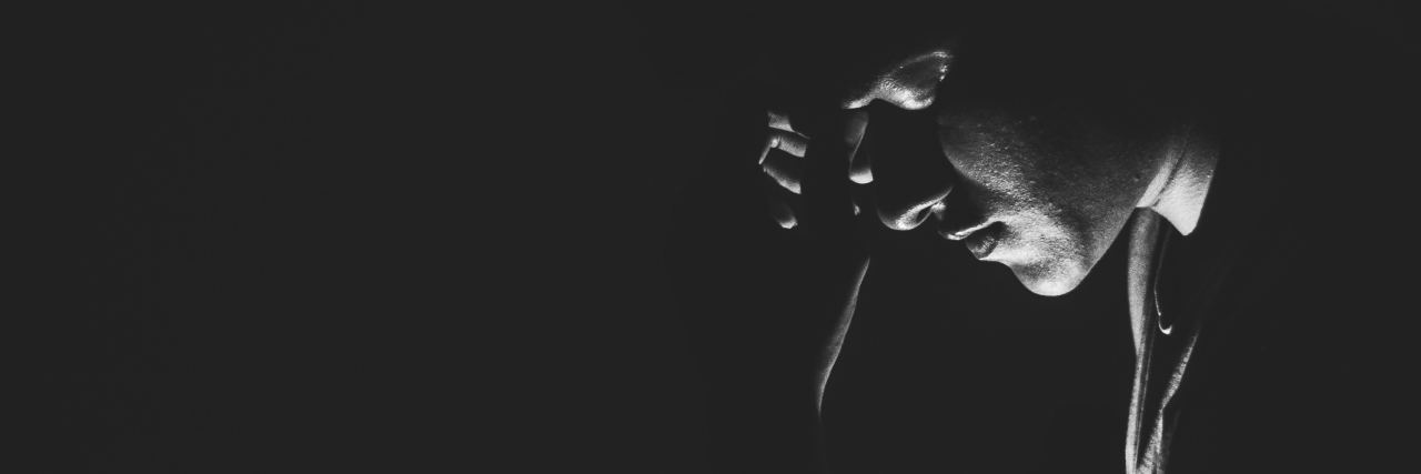 It’s OK to Be Embarrassed About Depression man in darkness with only face profile light