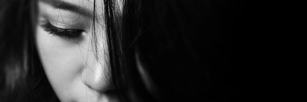 Why Living With Chronic Illness Is Not a 'Gift' black and white close up photo of a woman's face