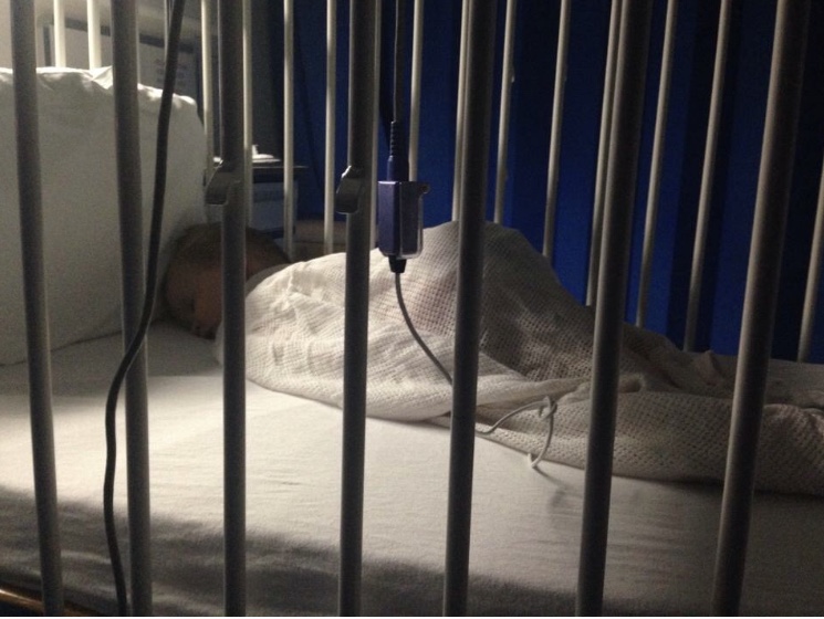 brody lying in a hospital crib