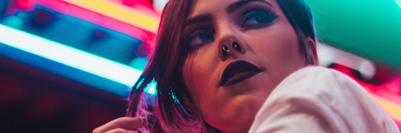 What Overthinking Actually Is, Because It's So Much More Than Worrying woman neon lights background