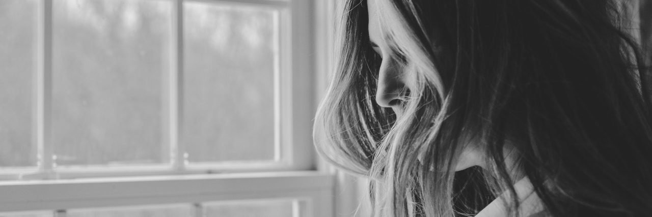 Should I Have Children If I Have Bipolar Disorder? black and white photo of woman looking out of window