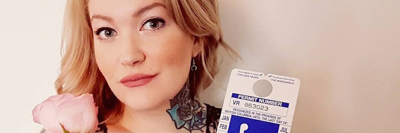 Why I Put My Rheumatoid Arthritis on My Online Dating Profile elieen davidson holding a disability parking placard and a rose