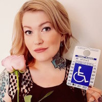 elieen davidson holding a disability parking placard and a rose
