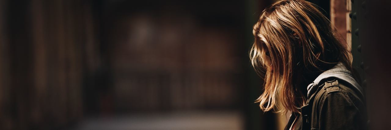 I'm an Honest Person – Until You Ask Me, 'How Are You?' A photo of a woman in a hallway.