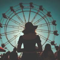woman standing in front of a ferris wheel