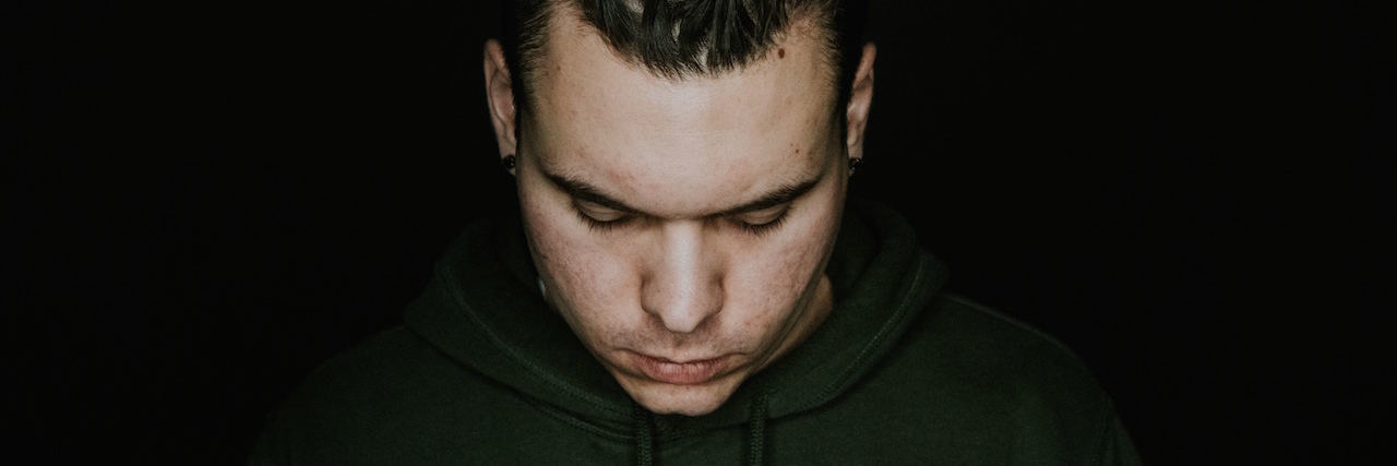 What I've Learned as a Man With Mental Illnesses A man looking down