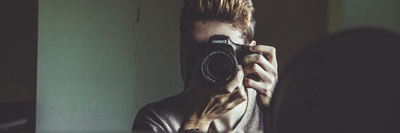How My 'Self-Care' Turned Into Self-Harm man taking self-portrait in mirror with canon camera