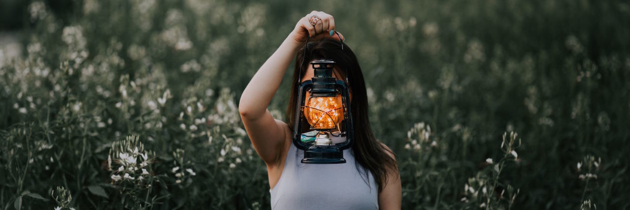 To Those Who Don't Feel 'Good Enough' woman with light in front of face