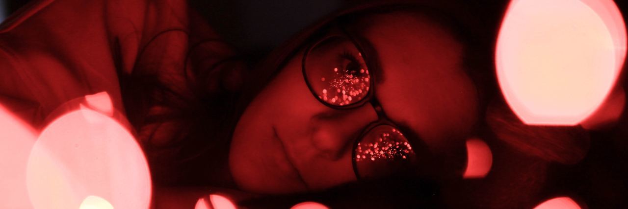 woman with light reflecting off her glasses