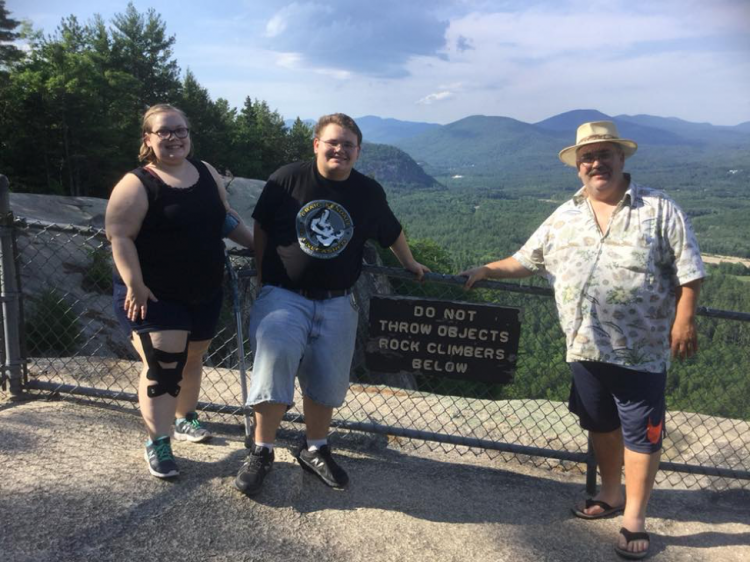 three hikers near the mountains