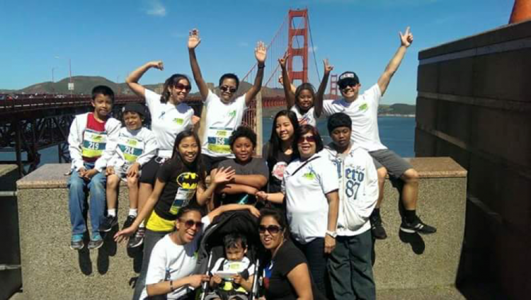 smiling family cheering near golden gate bridge