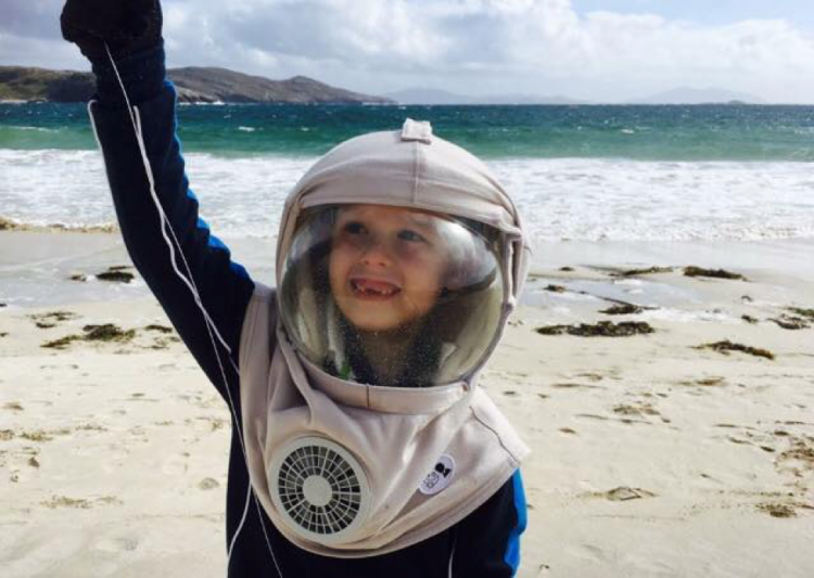 boy with helmet near beach