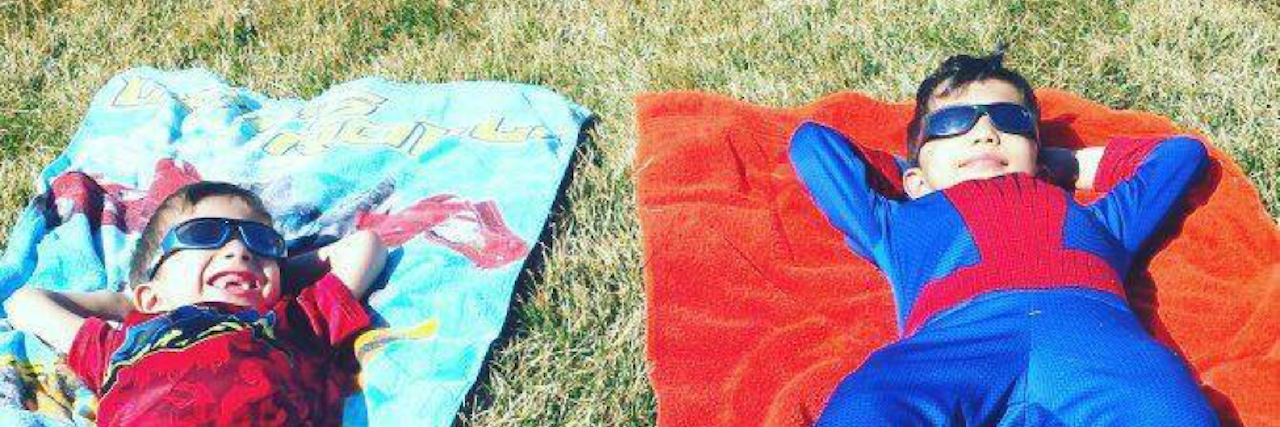 Confessions of People Facing Rare Disease: This Is Life two brothers smiling, laying on the ground