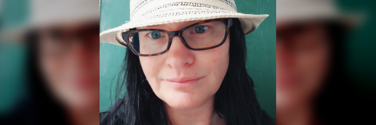 A Reminder to Anyone Struggling With Fibromyalgia author of the article wearing a hat and glasses