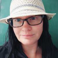author of the article wearing a hat and glasses