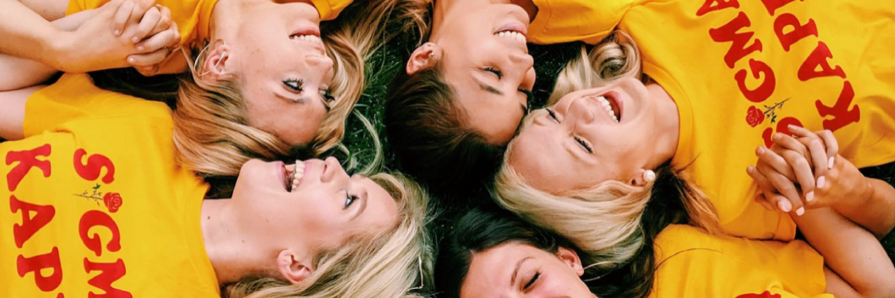 Talkspace Provides Tele-Therapy to Sigma Kappa Sorority Members Across the U.S. Sigma Kappa members laying in grass with yellow shirts with red letter that says "Sigma Kappa."