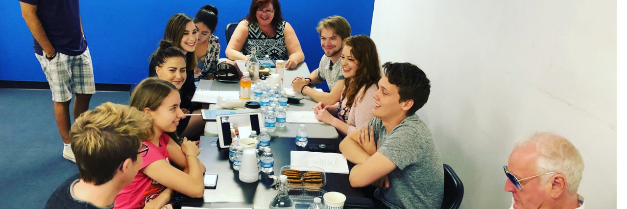 The cast of (Sorta) Supportive at a table read for the show.