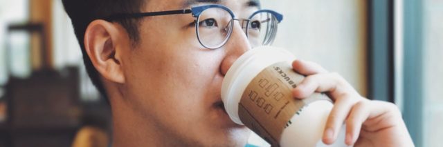 asian man drinking coffee