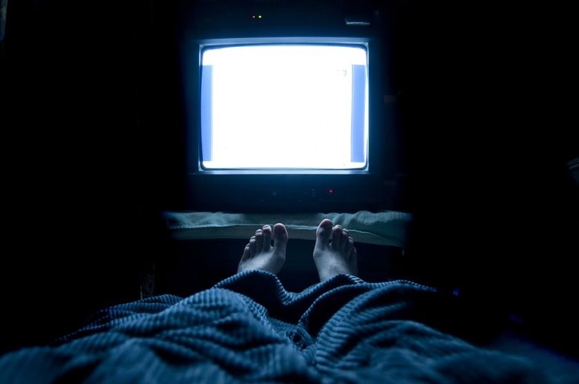person watching tv at night