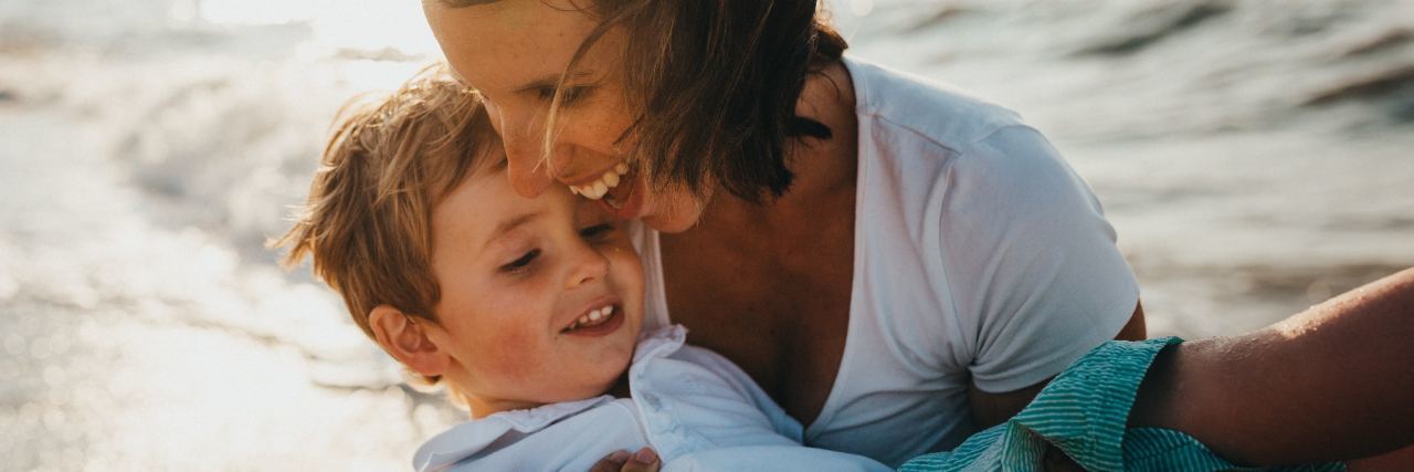 mother and son having fun on beach