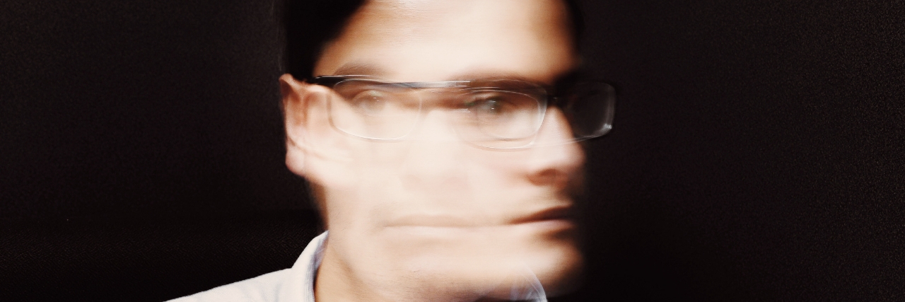 11 Unexpected Grounding Techniques for Dissociation A blurry man. Text reads: 11 Unexpected Ways People 'Bring Themselves Back' From Dissociation