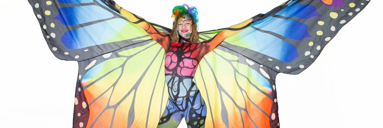 model wearing body paint and butterfly wings