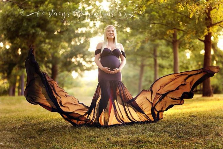 woman's maternity photo wearing long dress that looks like wings