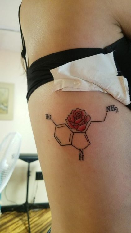 Tattoo of a serotonin molecule with a rose.