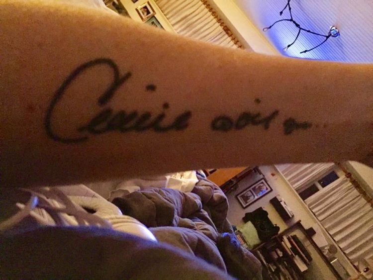 An arm tattoo of Celine Dion's autograph.