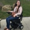 Pippa outdoors in her wheelchair.