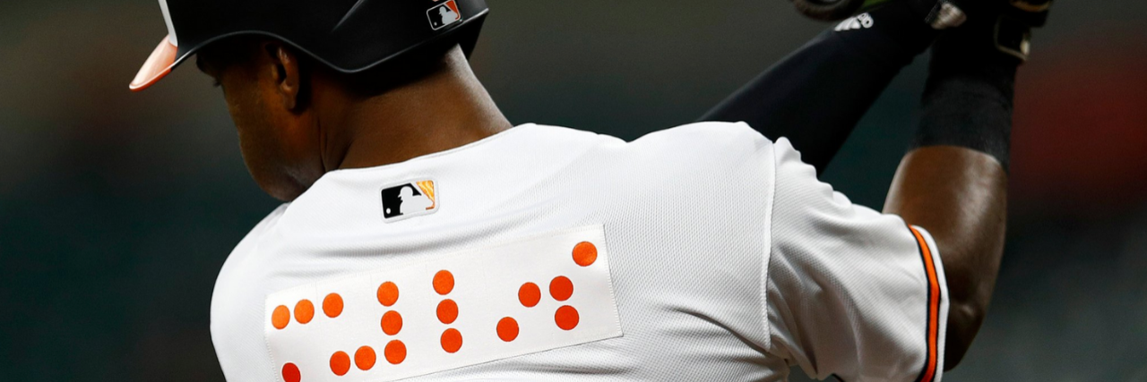 Baltimore Orioles Honors NFB With Braille Jerseys Back of a Baltimore Orioles jersey with orange braille lettering.