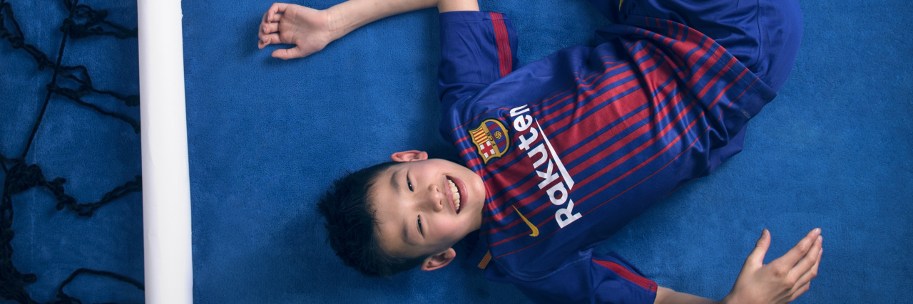 Growing Up With Cerebral Palsy in China Eliott Hu with a soccer ball.