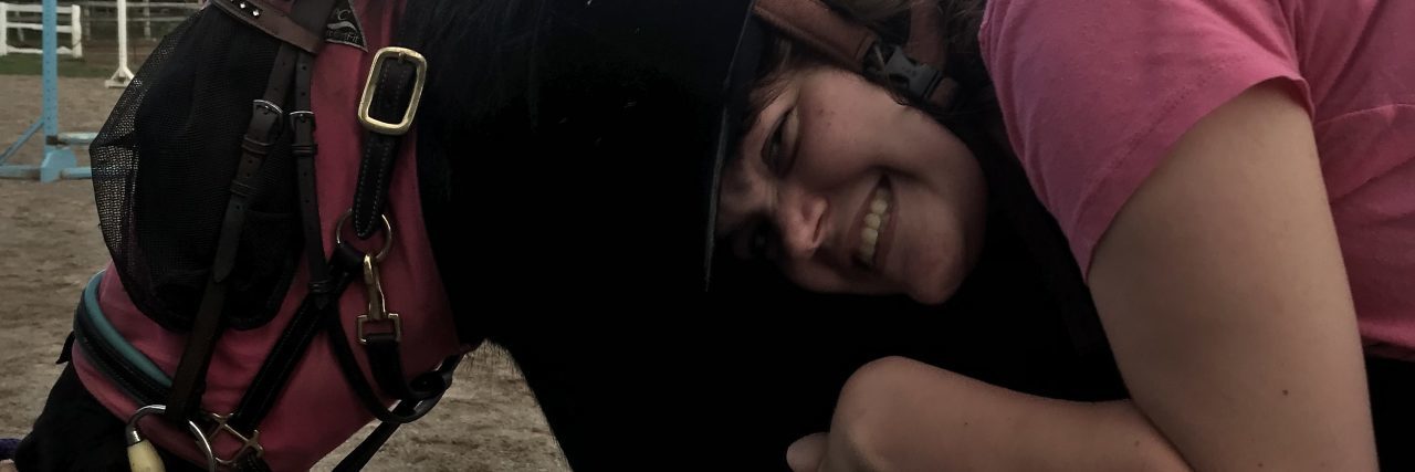 Benefits of Horseback Riding for People With Cerebral Palsy Maddy, a young woman with cerebral palsy horseback riding.