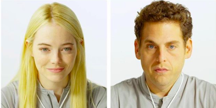 Annie (Emma Stone) wearing a gray jumpsuit and Owen (Jonah Hill) wearing the same one.