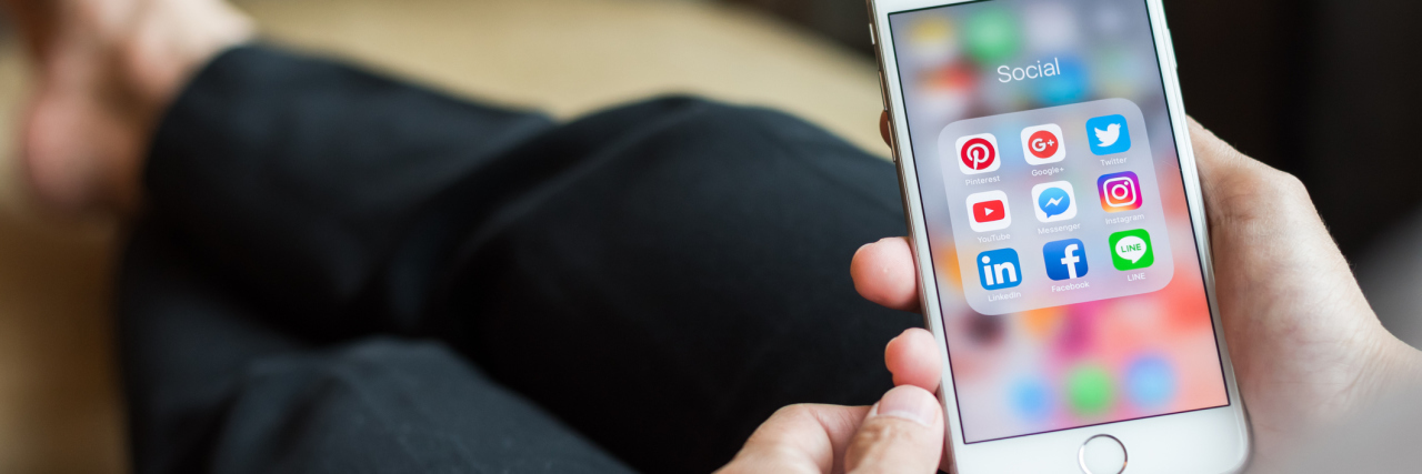 The Reality of Anorexia Recovery person holding phone with social media app icons